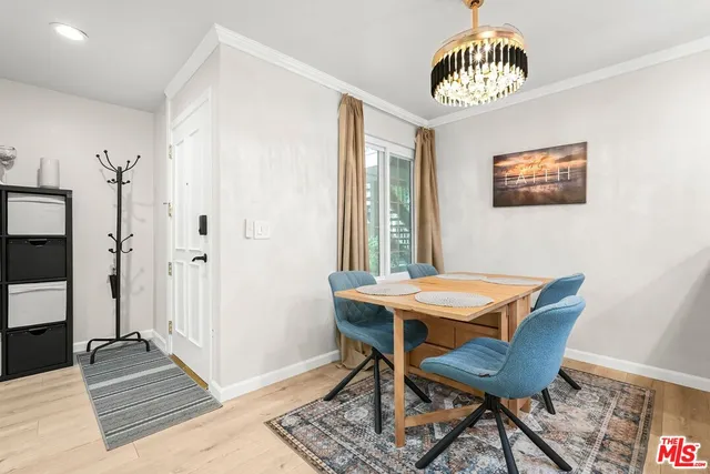 a view of a room with a table and chairs