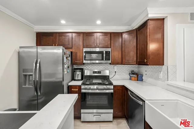 a kitchen with a refrigerator and a sink