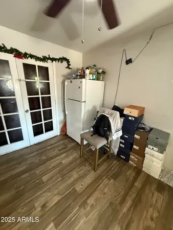 a view of a room with wooden floor and windows