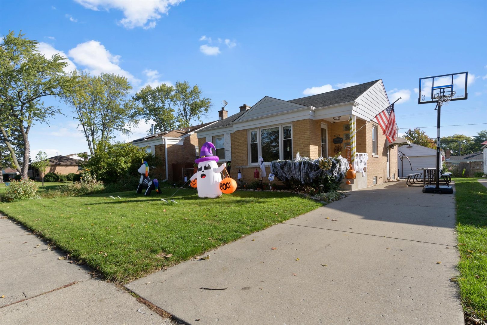 8151 Washington Street Niles, IL 60714 - Photo 2 of 18 a front view of a house with garden and a tree