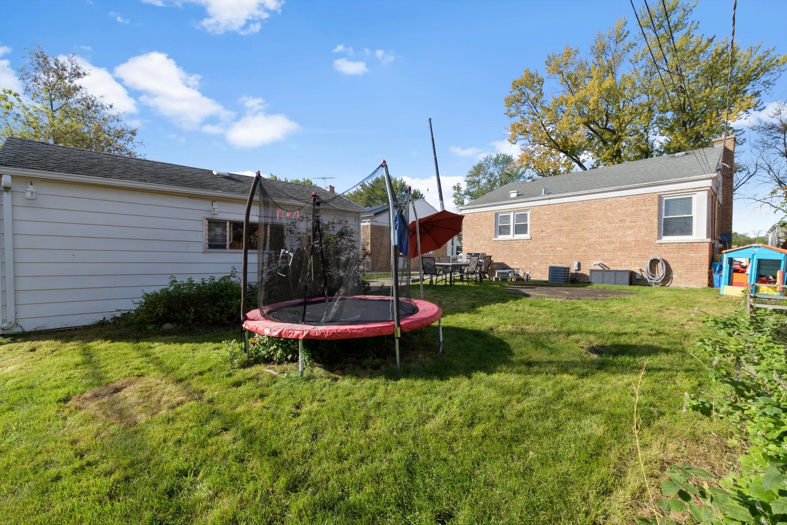 8151 Washington Street Niles, IL 60714 - Photo 18 of 18 a view of a chair and table in backyard of the house