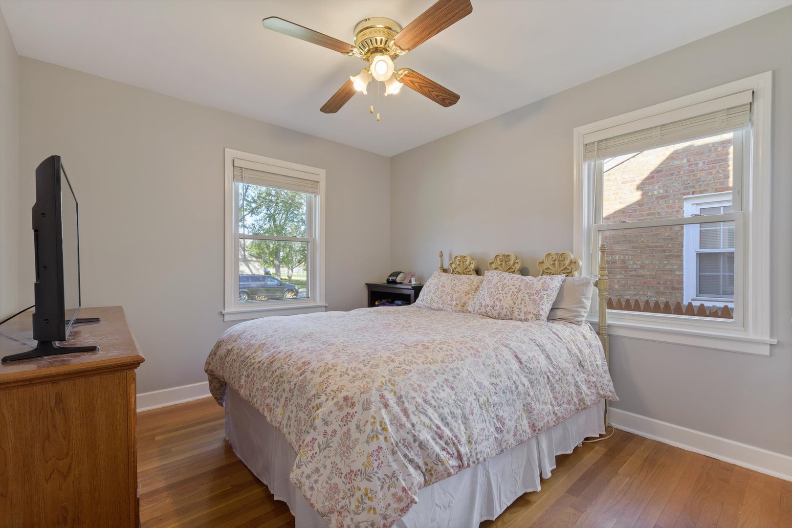 8151 Washington Street Niles, IL 60714 - Photo 9 of 18 a bedroom with a bed tv and a window