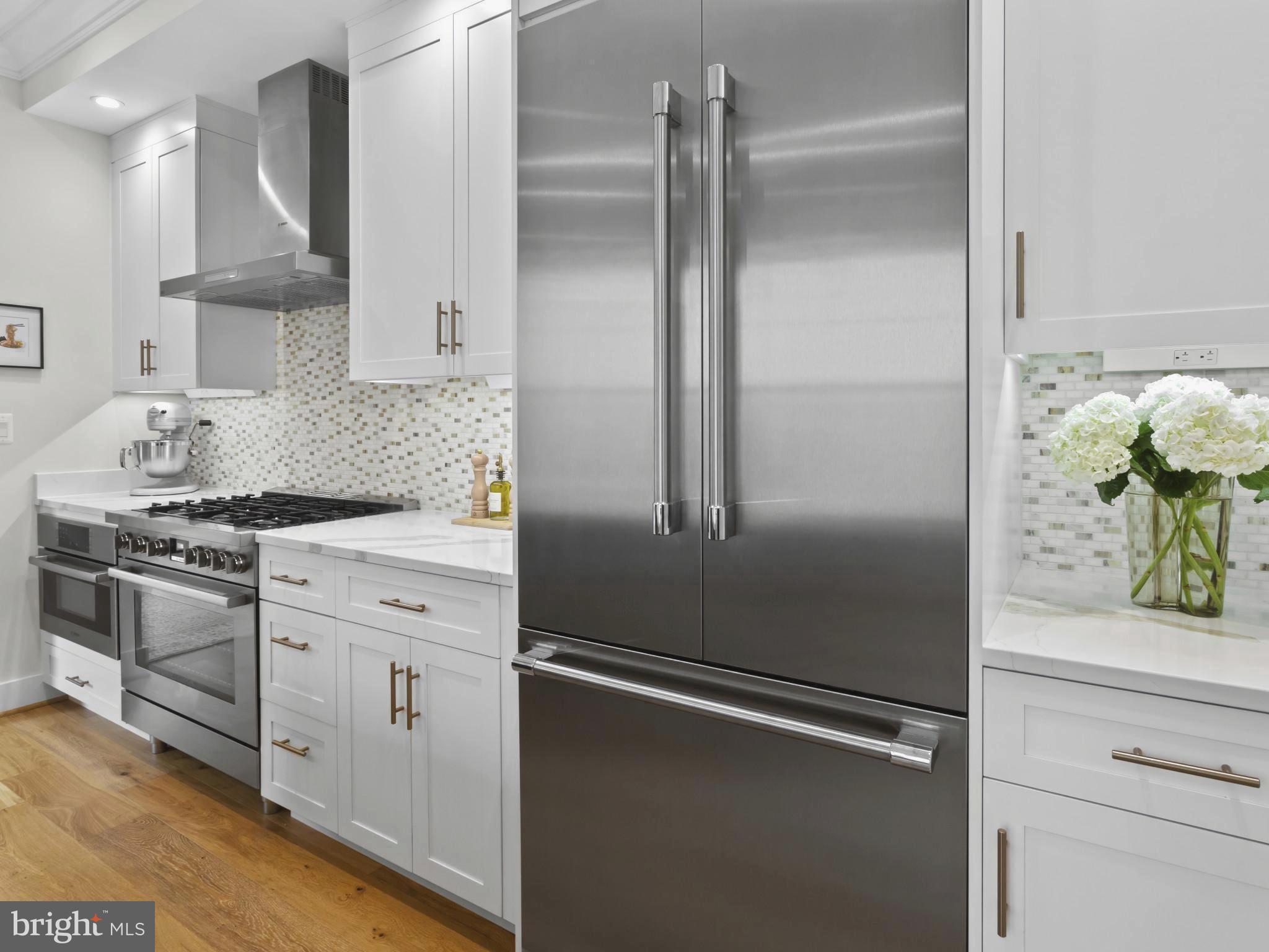 910 8th Street Northeast Washington, DC 20002 - Photo 11 of 54 a kitchen with a refrigerator and a stove top oven