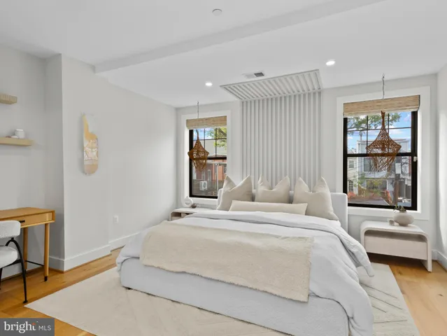 a bedroom with a large bed and a chandelier