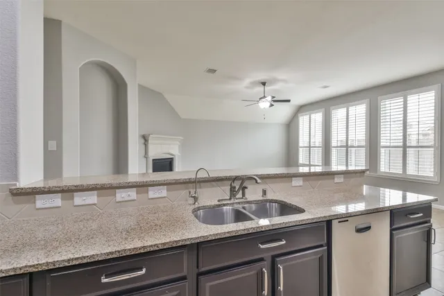 a view of an empty room with window and cabinet
