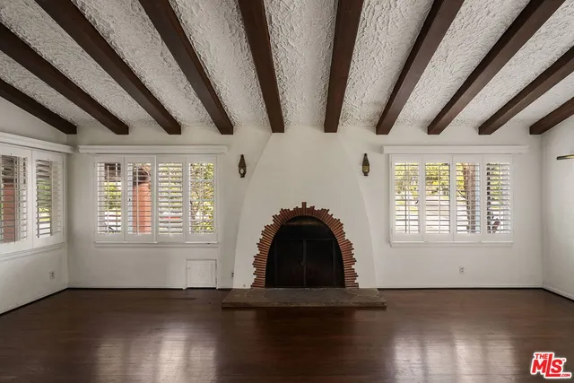 a view of a livingroom with wooden floor and a window
