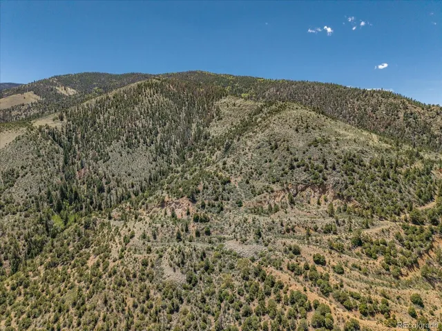 a view of a large building with mountains in the background