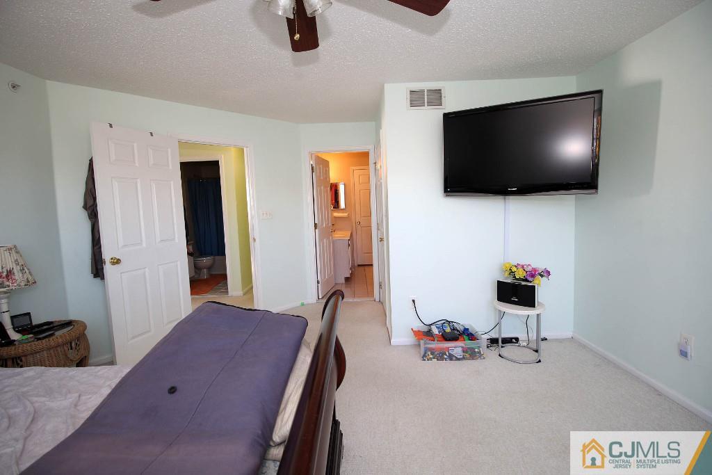 37 Inverness Drive Edison, NJ 08820 - Photo 18 of 25 a bedroom with a bed and a flat screen tv