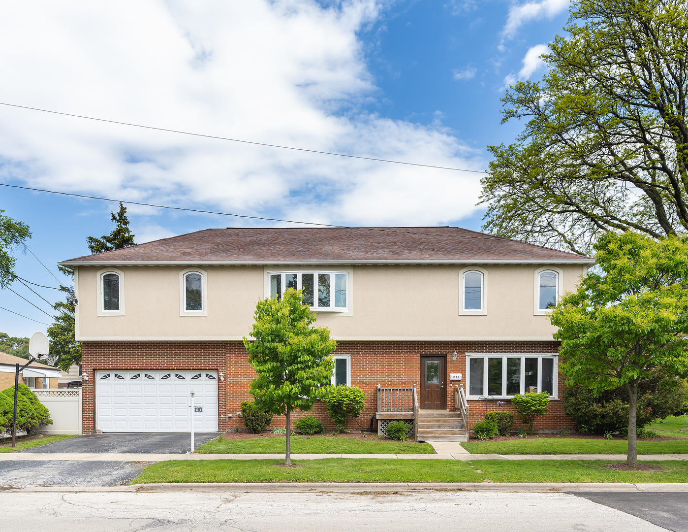 8330 Gross Point Road Morton Grove, IL 60053 - Photo 1 of 22 a view of a white house with a yard and plants