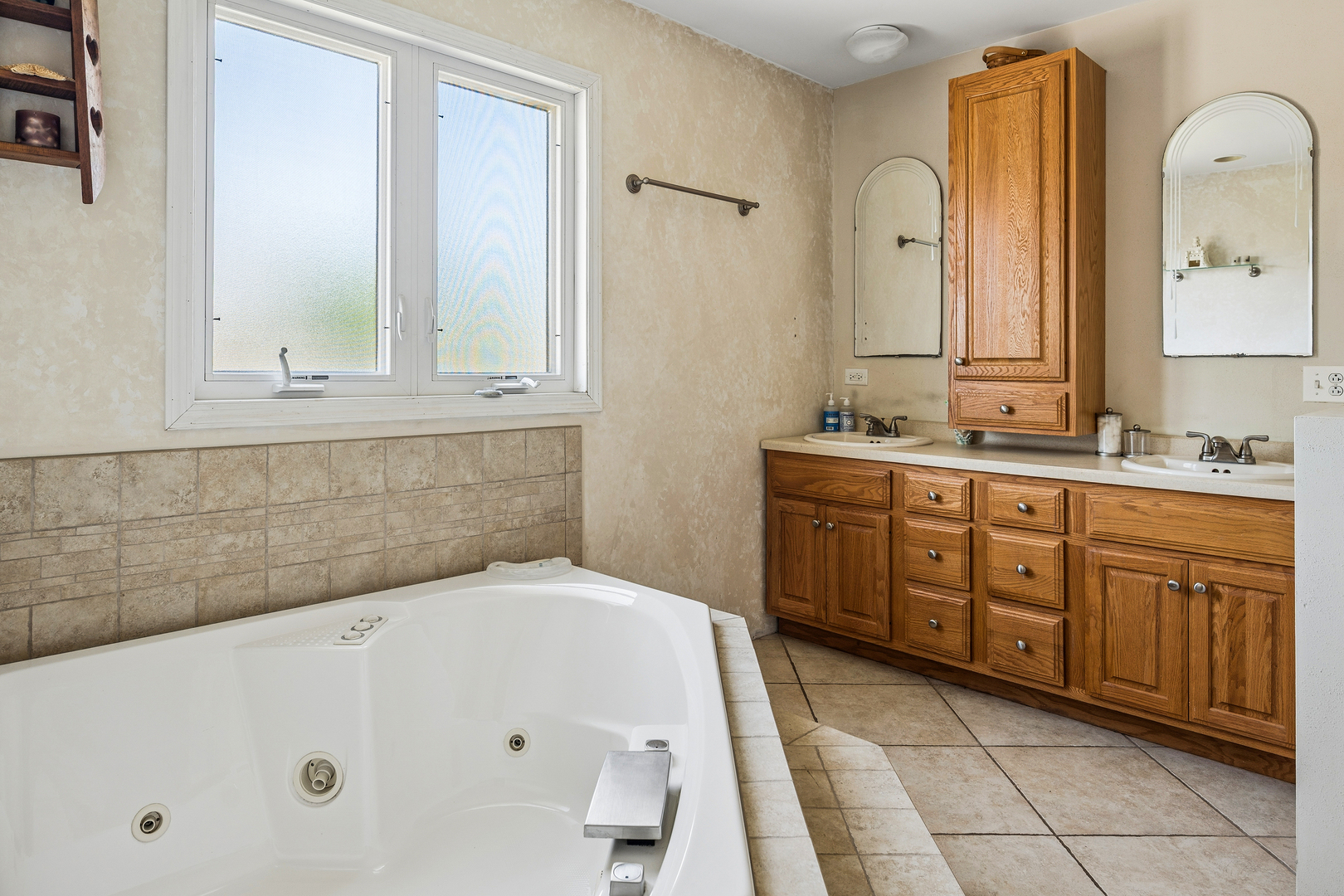 8330 Gross Point Road Morton Grove, IL 60053 - Photo 16 of 22 a bathroom with a tub sink and mirror