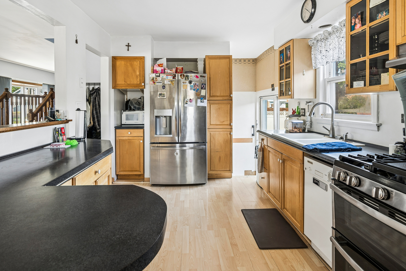 8330 Gross Point Road Morton Grove, IL 60053 - Photo 5 of 22 a kitchen with stainless steel appliances granite countertop a refrigerator a stove and a sink with wooden floor