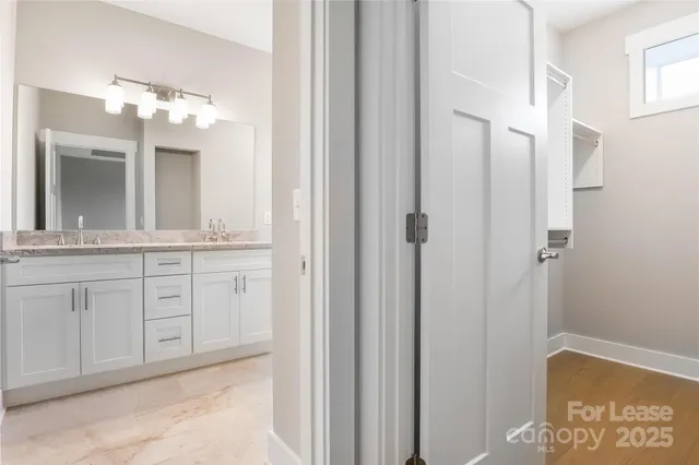 a bathroom with a double vanity sink and a mirror