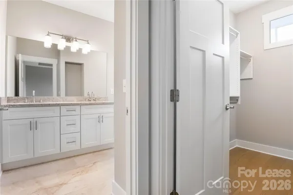 a bathroom with a double vanity sink and a mirror