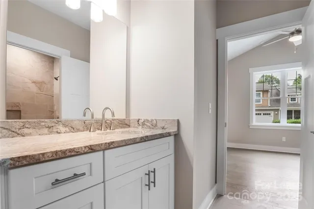 a bathroom with a granite countertop sink and a mirror