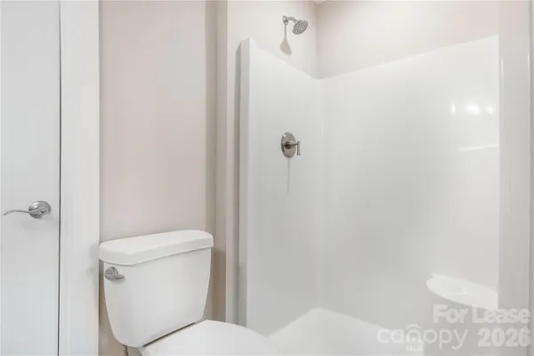 a white toilet sitting next to a bathroom sink