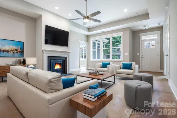 a living room with furniture a flat screen tv and a fireplace