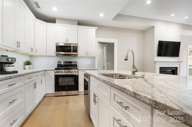 a kitchen with granite countertop a stove and a sink