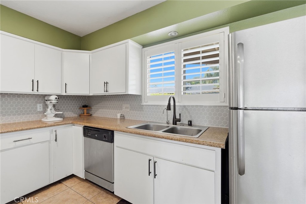 1237 South Clover Street Visalia, CA 93277 - Photo 14 of 30 a kitchen with a sink and cabinets