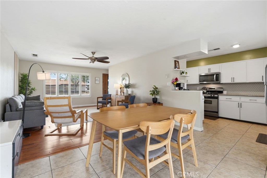 1237 South Clover Street Visalia, CA 93277 - Photo 17 of 30 a dining room with wooden floor and kitchen view