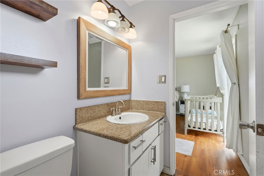 1237 South Clover Street Visalia, CA 93277 - Photo 20 of 30 a bathroom with a sink vanity granite and toilet