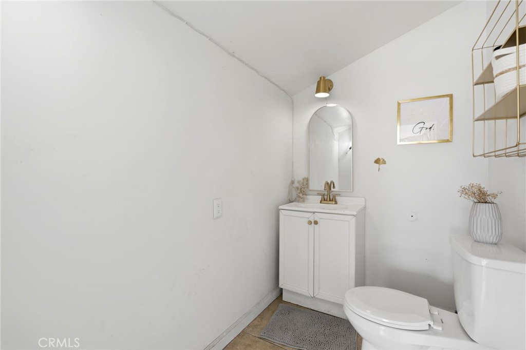 1237 South Clover Street Visalia, CA 93277 - Photo 21 of 30 a bathroom with a sink vanity mirror and toilet