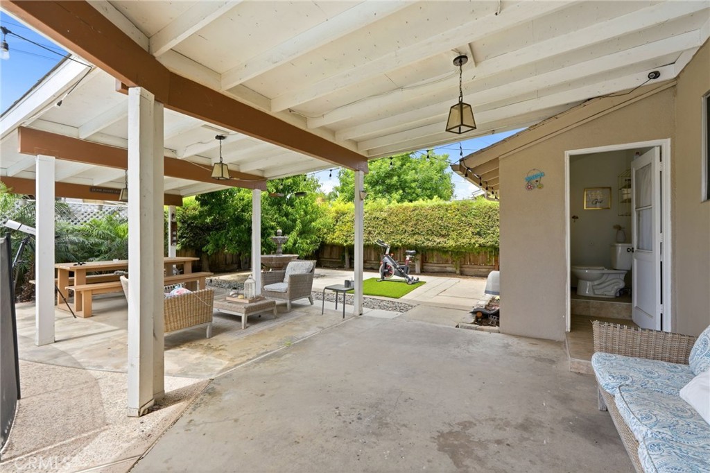 1237 South Clover Street Visalia, CA 93277 - Photo 26 of 30 a view of a patio with a table chairs and a backyard