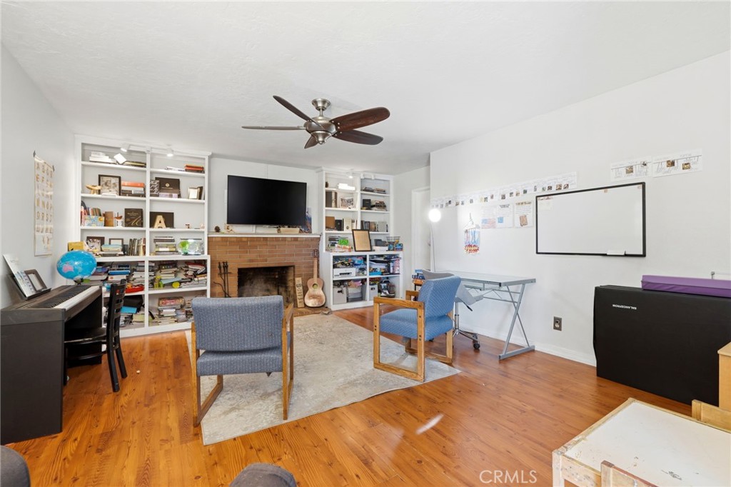 1237 South Clover Street Visalia, CA 93277 - Photo 6 of 30 a living room with furniture a fireplace and a flat screen tv