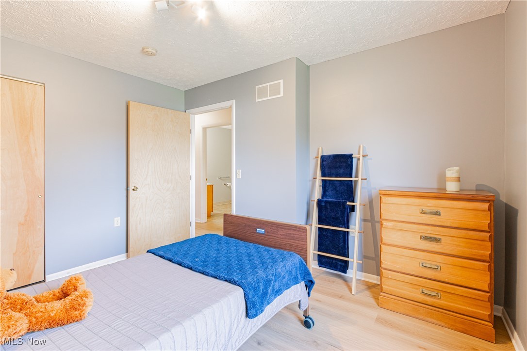 2643 Graham Road Stow, OH 44224 - Photo 13 of 30 Bedroom featuring a textured ceiling and light wood-type flooring