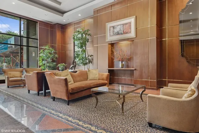 a living room with furniture and a potted plant