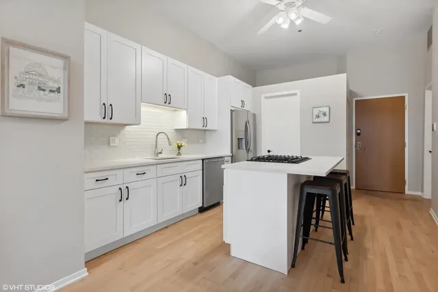 a kitchen with a sink cabinets and wooden floor