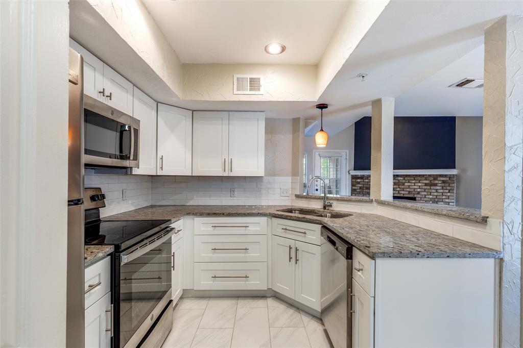 5565 Preston Oaks Road, Unit 237 Dallas, TX 75254 - Photo 1 of 14 a kitchen with stainless steel appliances granite countertop a sink and stove top oven