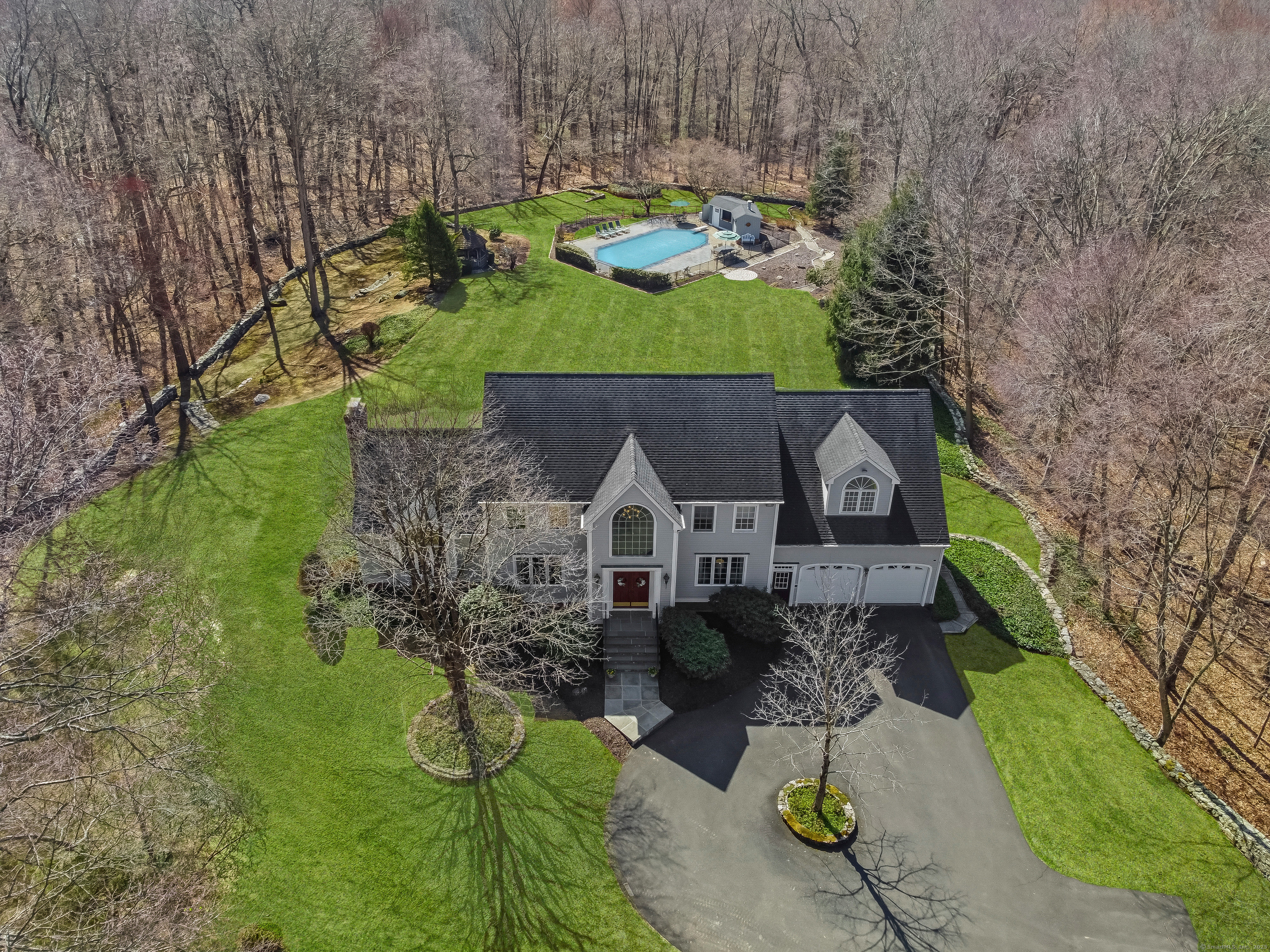 an aerial view of a house with a yard