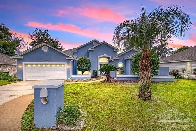 a view of a house with swimming pool and a fire pit