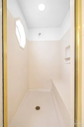 a view of a lake with a bench and trees around