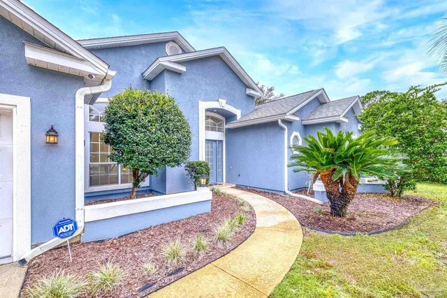 a front view of a house with garden