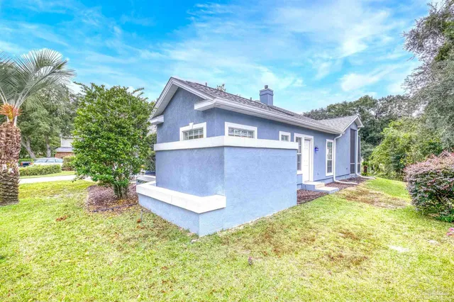 a view of a house with backyard and sitting area