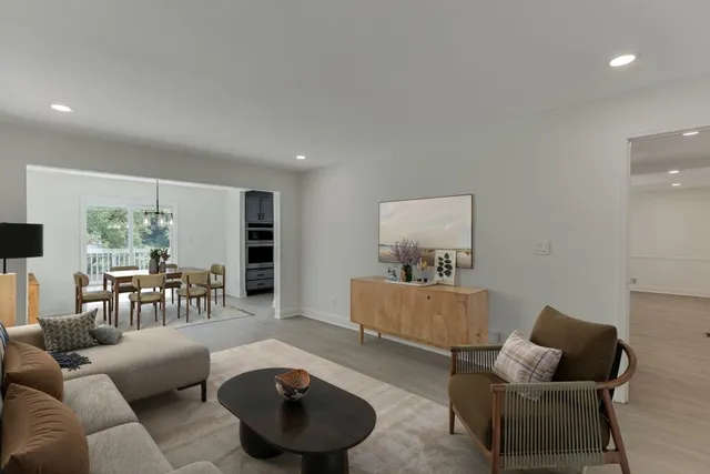 a large kitchen with stainless steel appliances a stove refrigerator and a microwave