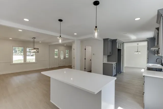 an empty room with a window and a ceiling fan