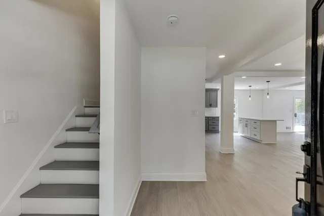 an empty room with a windows and ceiling fan