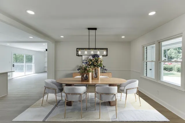 an empty room with large window and wooden floor