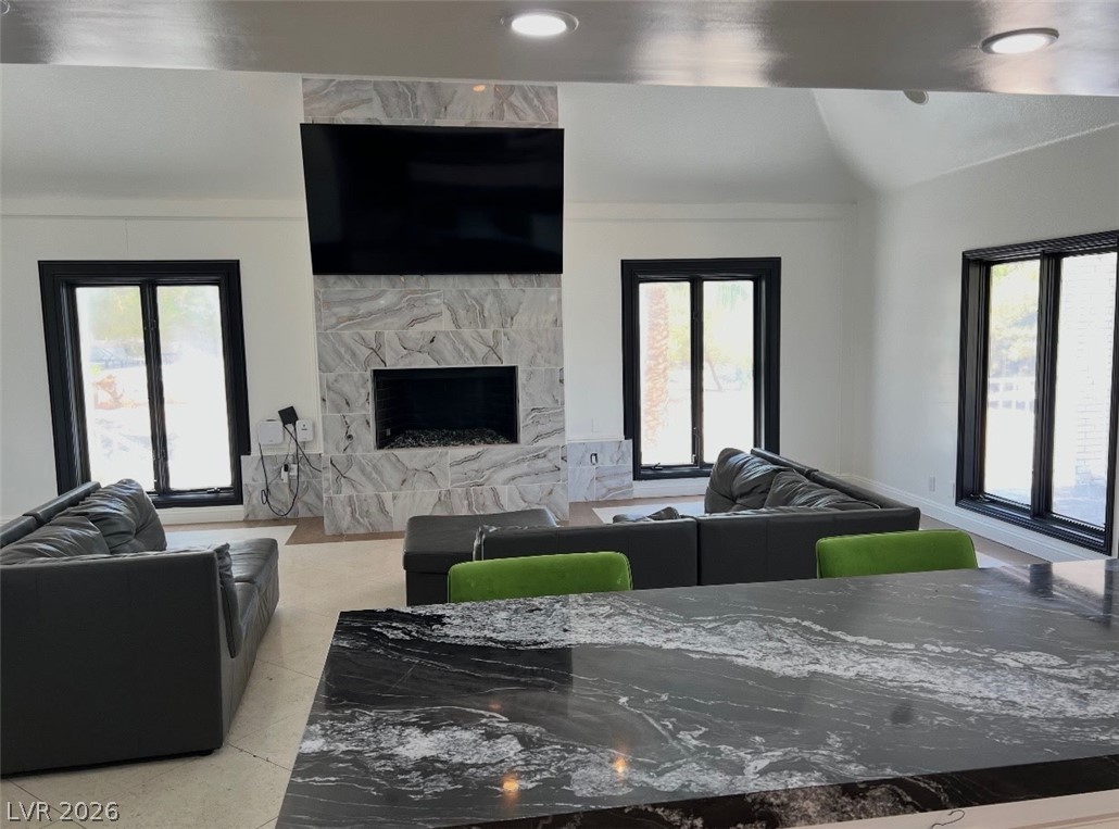 3003 Regency Hill Henderson, NV 89014 - Photo 2 of 13 A striking marbled fireplace with a sleek television above anchors this expansive living area.