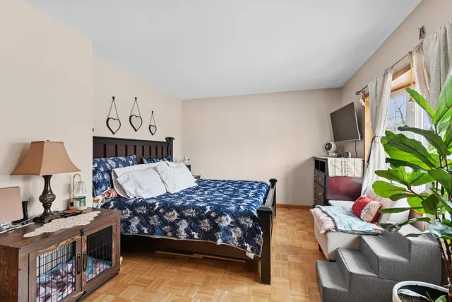 a bedroom with a large bed and a large window