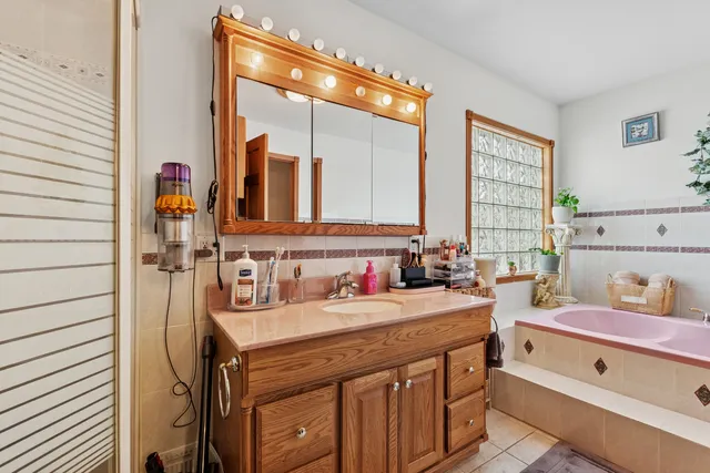 a bathroom with a sink mirror vanity and toilet