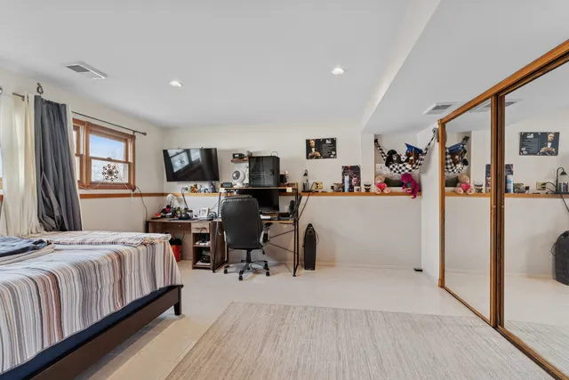 a living room with furniture and a piano