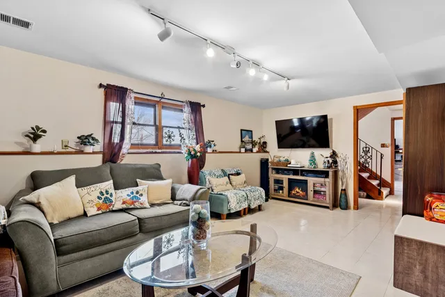 a bedroom with a bed couch and a window