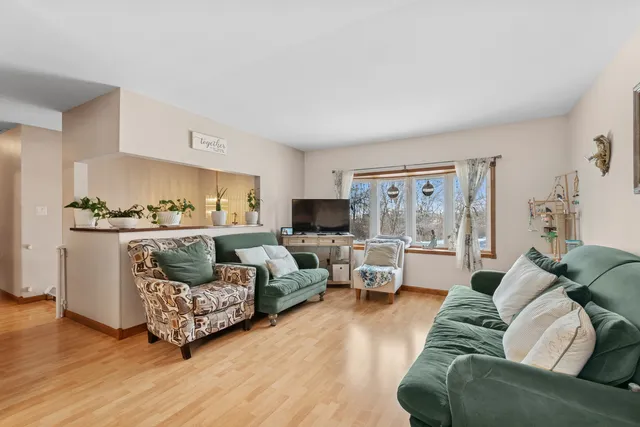 a living room with furniture and view of kitchen