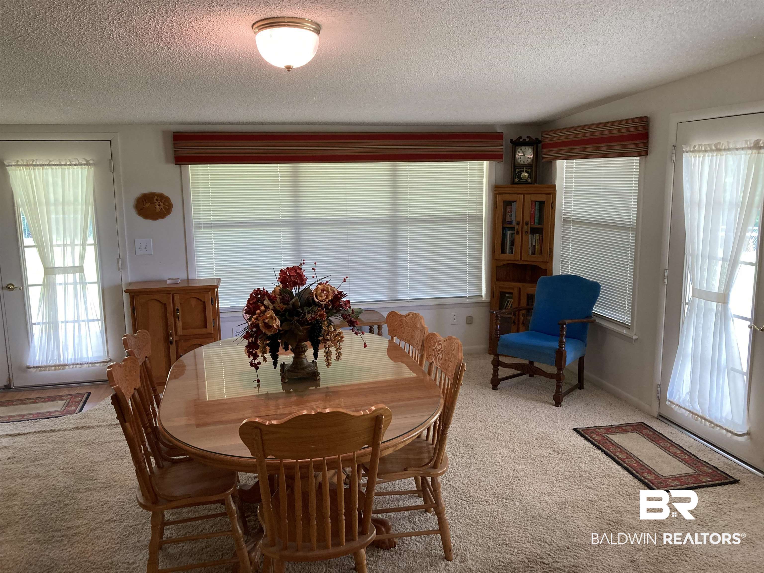 6151 Meadows Road Walnut Hill, FL 32568 - Photo 12 of 29 Carpeted dining area featuring a textured ceiling