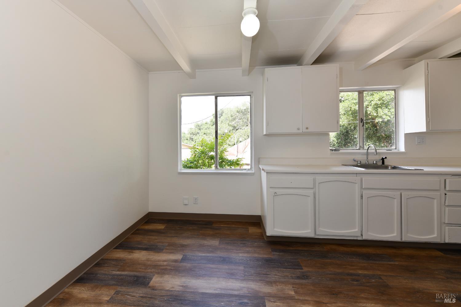 1577 Silverado Trail Napa, CA 94559 - Photo 20 of 30 a kitchen with white cabinets window and sink