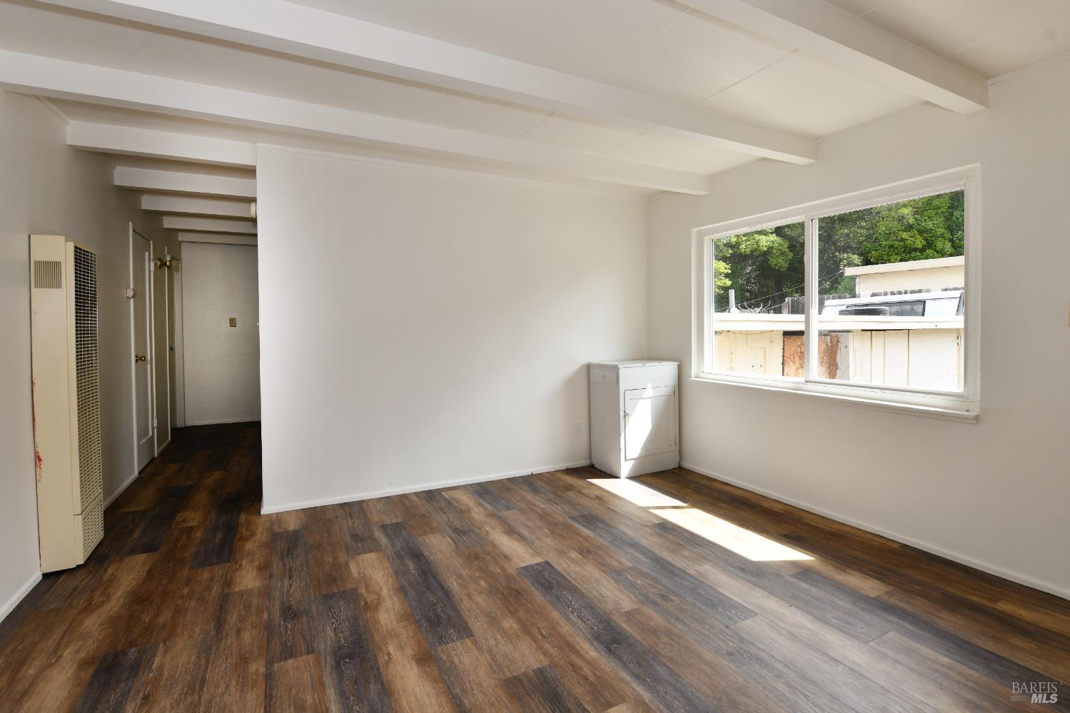 1577 Silverado Trail Napa, CA 94559 - Photo 21 of 30 a view of an empty room with wooden floor and a window