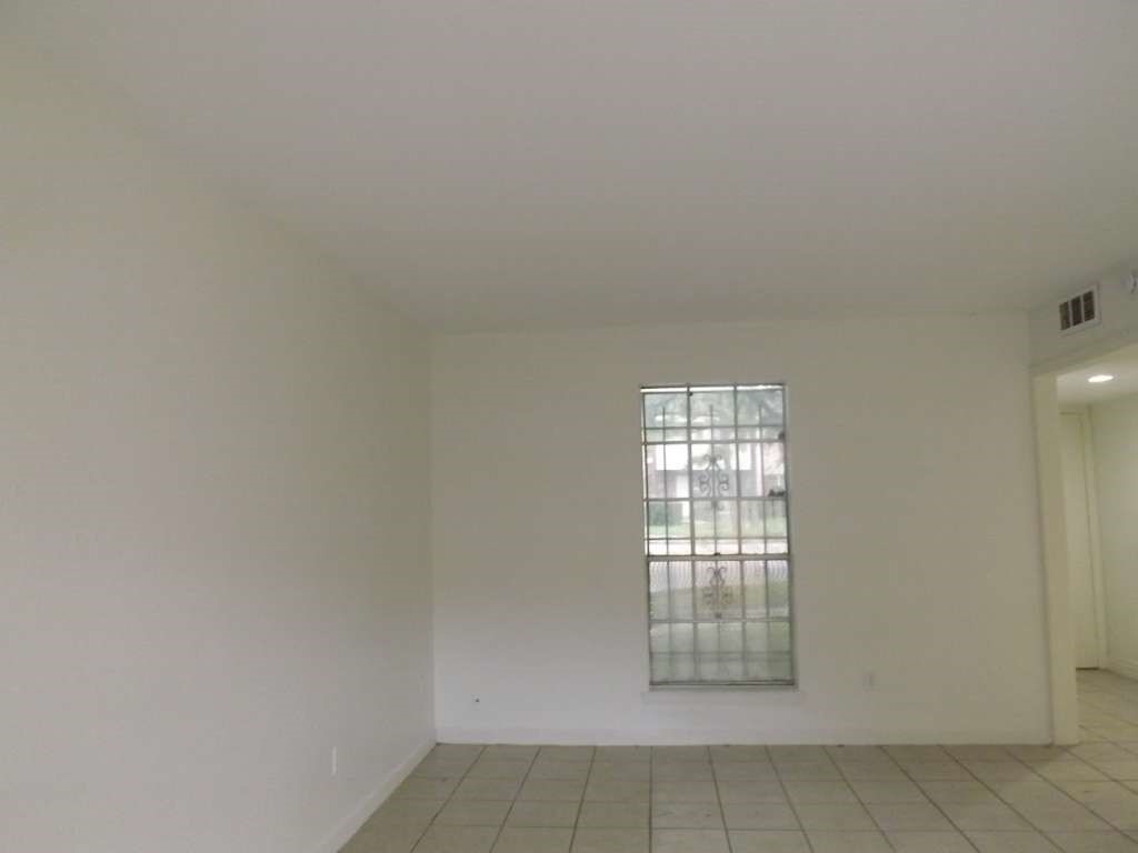 7936 Grove Ridge Drive Houston, TX 77061 - Photo 3 of 11 an empty room with windows